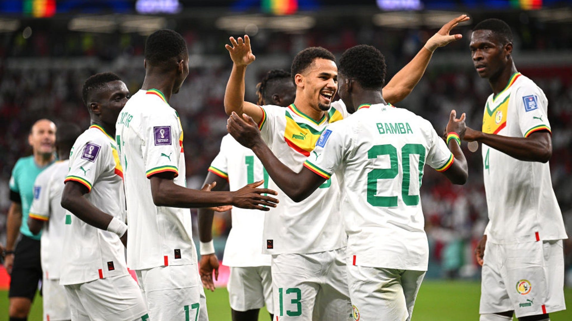 Senegal players celebrate after beating Qatar