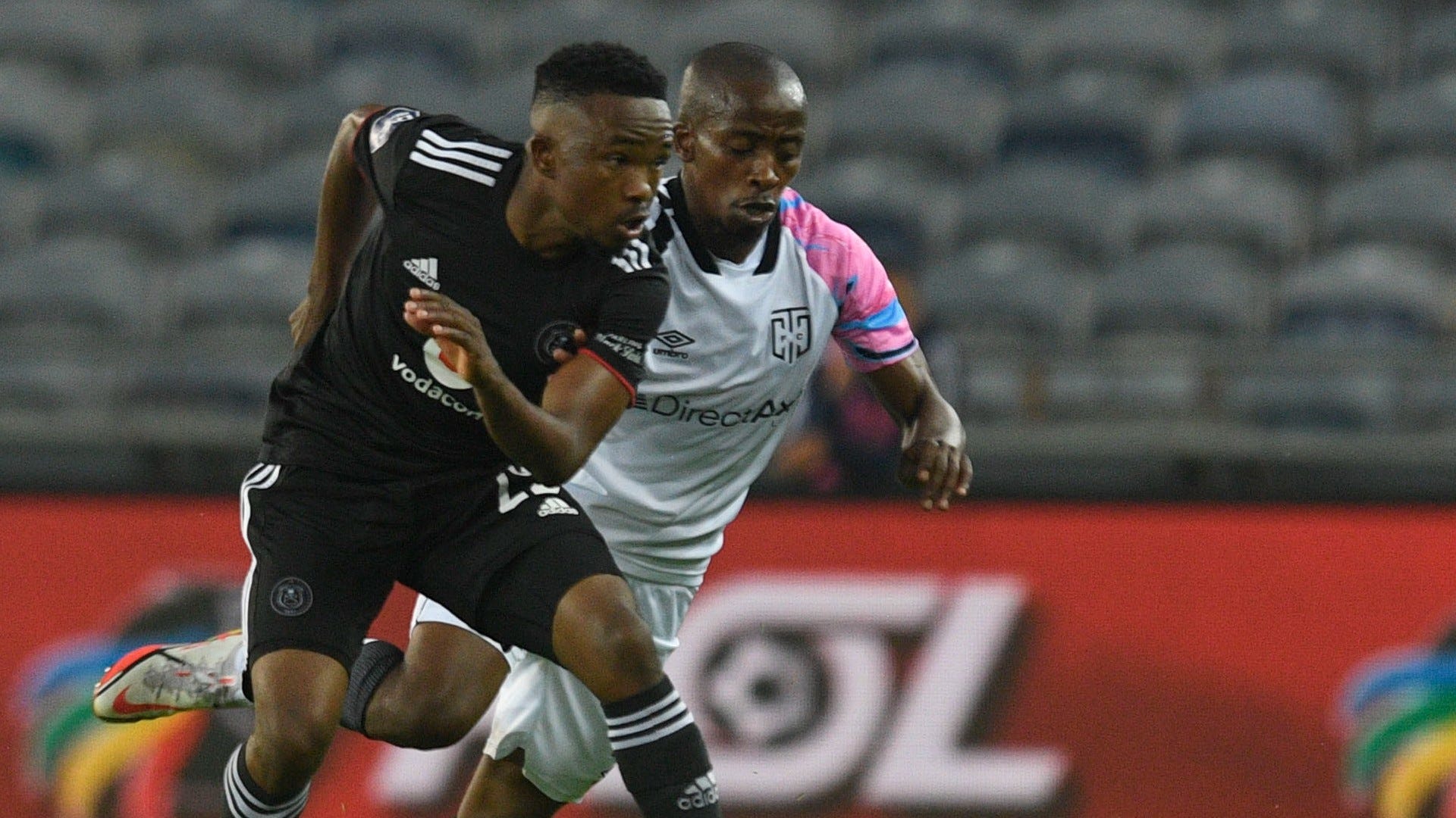 Paseka Mako of Orlando Pirates challenges Thabo Nodada of Cape Town City.