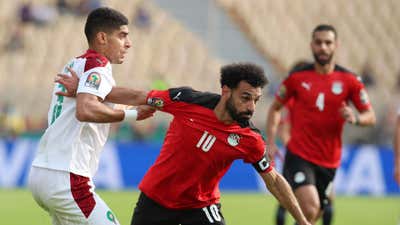 Mohamed Salah of Egypt challenged by Adam Masina of Morocco.