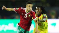 Noussair Mazraoui of Morocco is challenged by Sessi Dalmeida of Benin.