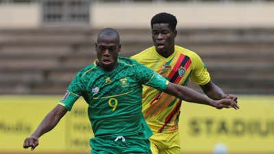 Evidence Makgopa of South Africa is challenged by Marshall Munetsi of Zimbabwe during the Qatar 2022 FIFA World Cup qualifier