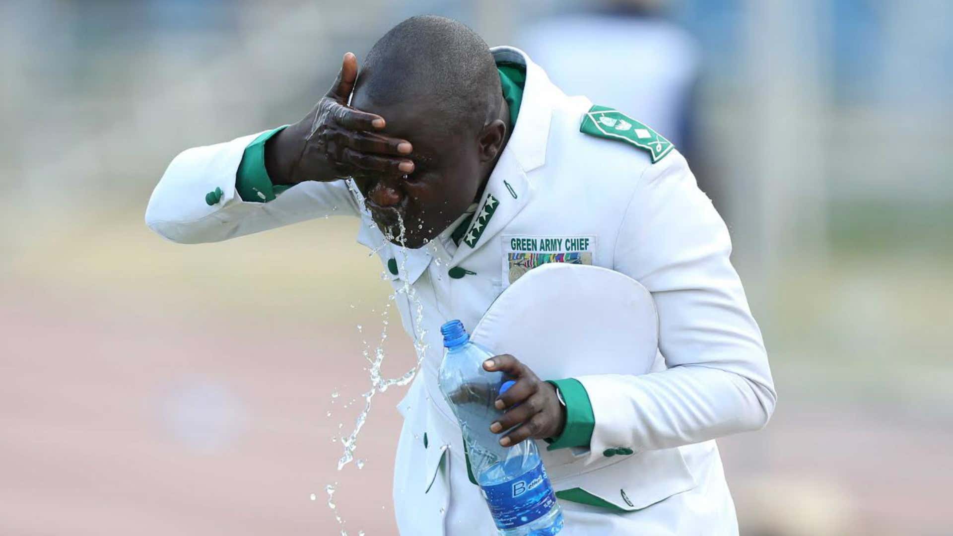 A Gor Mahia fan wipes off teargas after KPL Top 8 final turned chaotic on Sunday