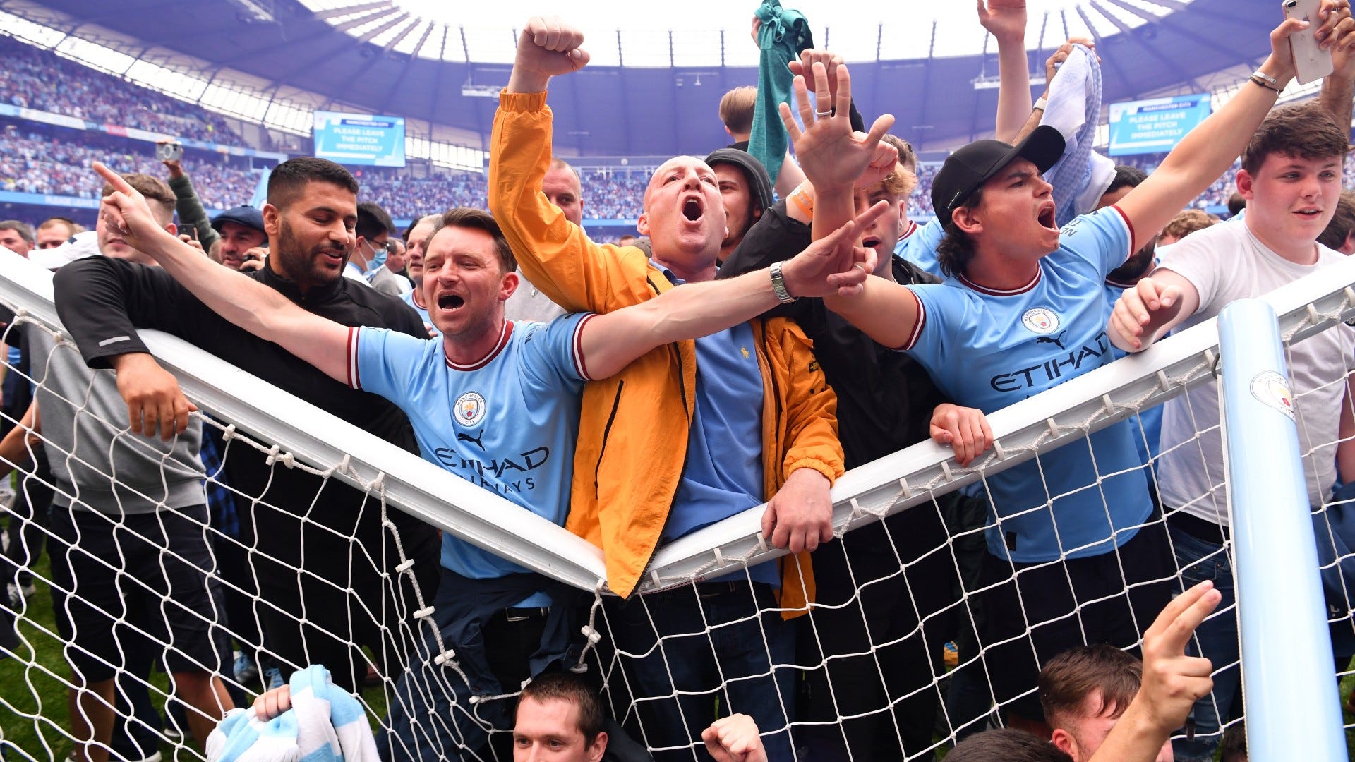 Manchester City fans goal posts pitch invasion