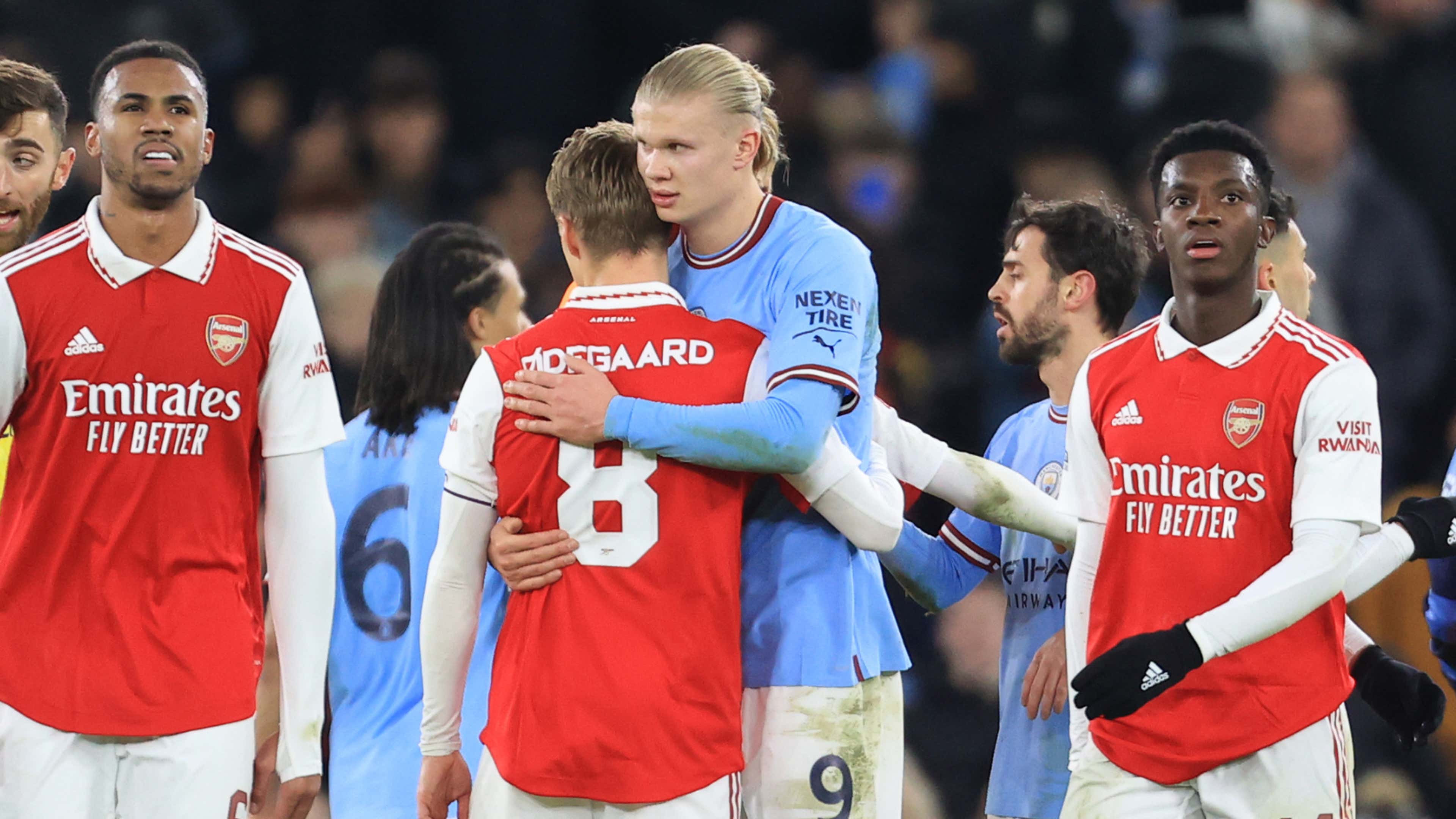 Martin Odegaard of Arsenal hugs Erling Haaland of Manchester City
