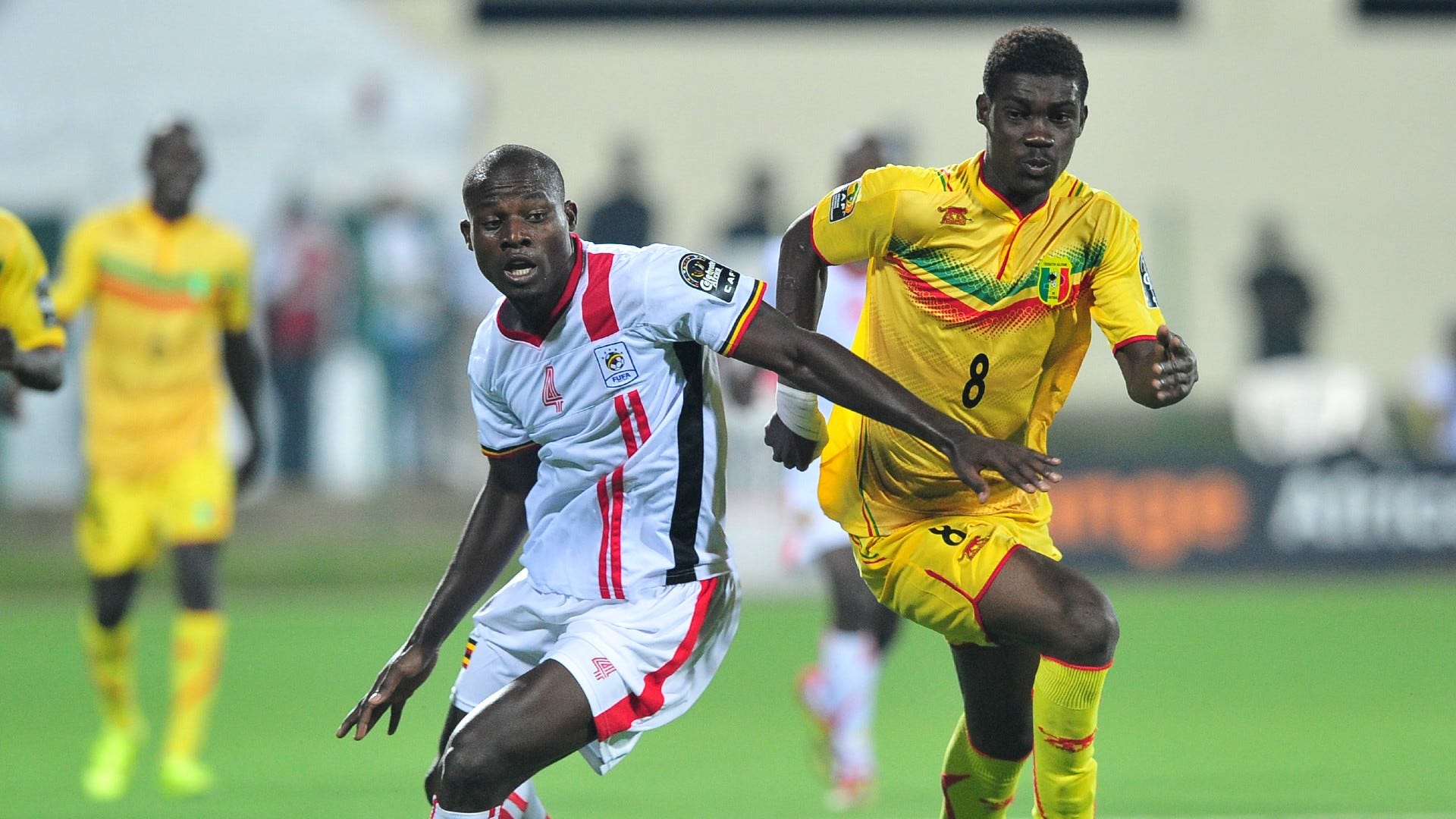 Yves Bissouma of Mali goes past Richard Kasagga of Uganda during the 2016 CHAN football match.