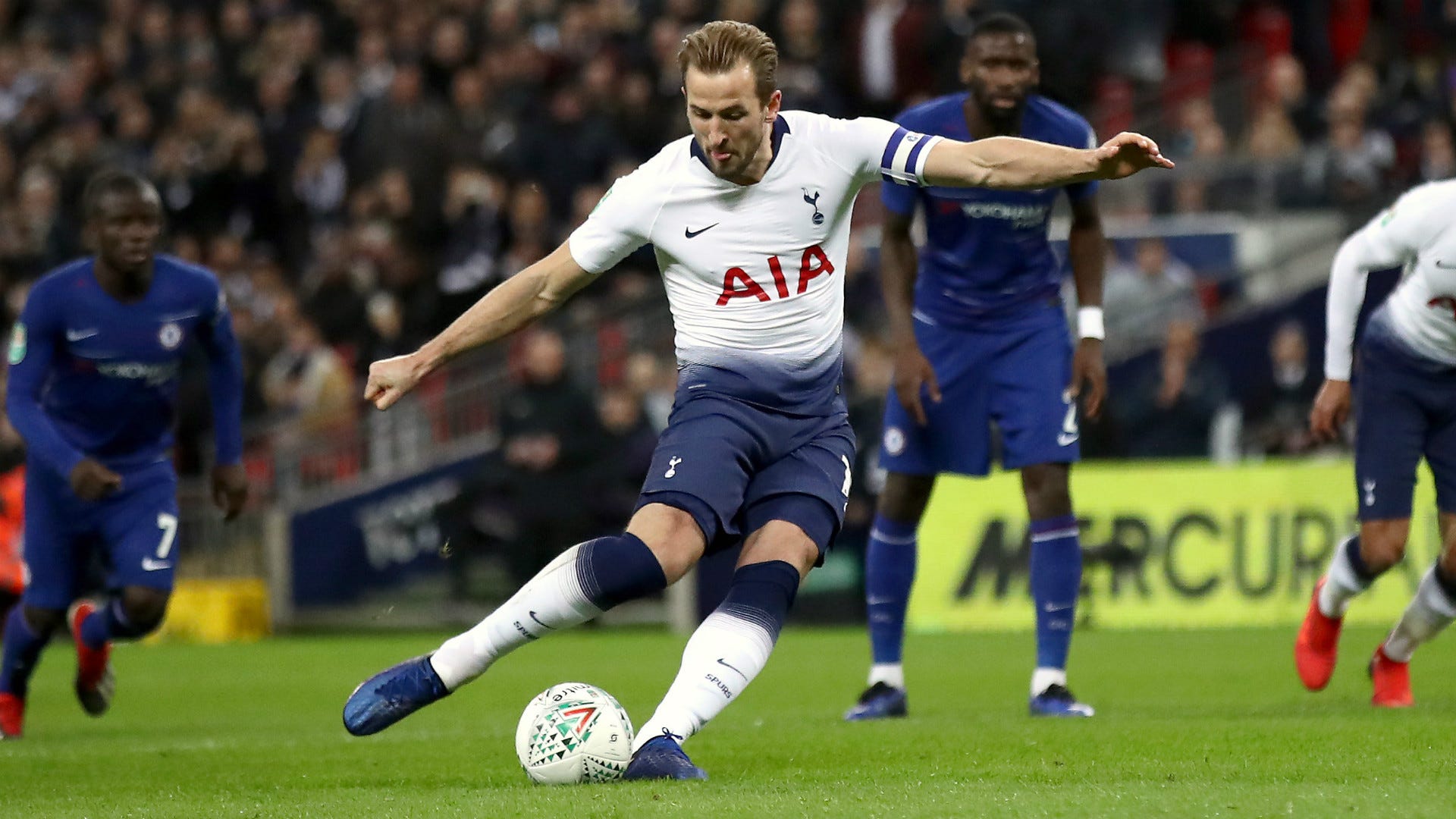  Harry Kane is seen scoring a goal past the Chelsea goalkeeper during a soccer match.