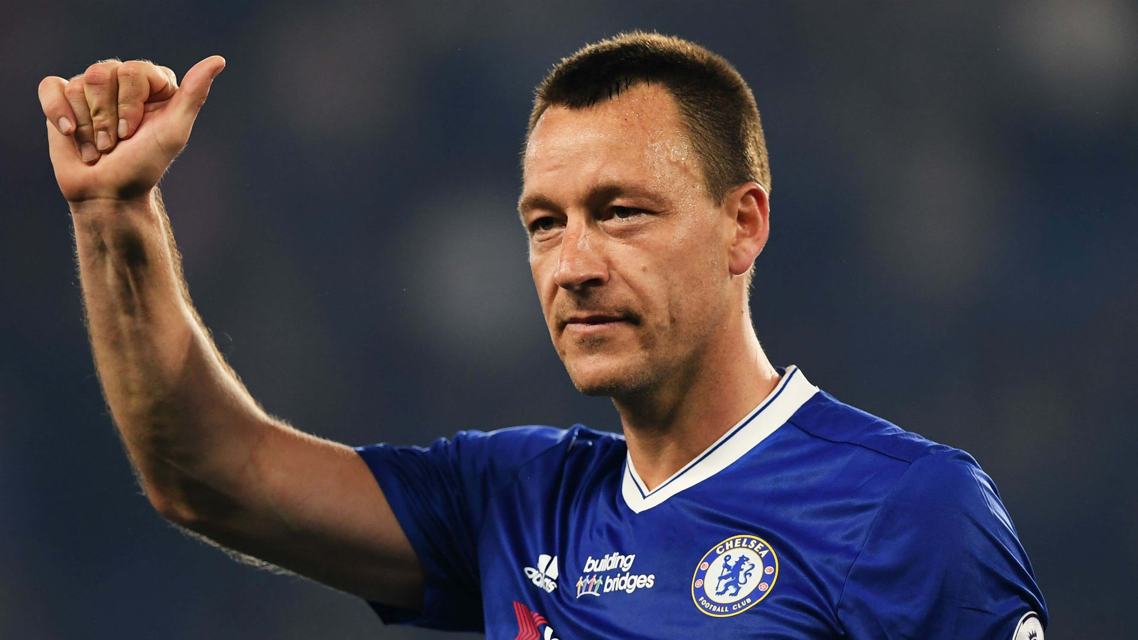  John Terry, a former Chelsea captain, celebrates a victory while wearing the team's blue kit.