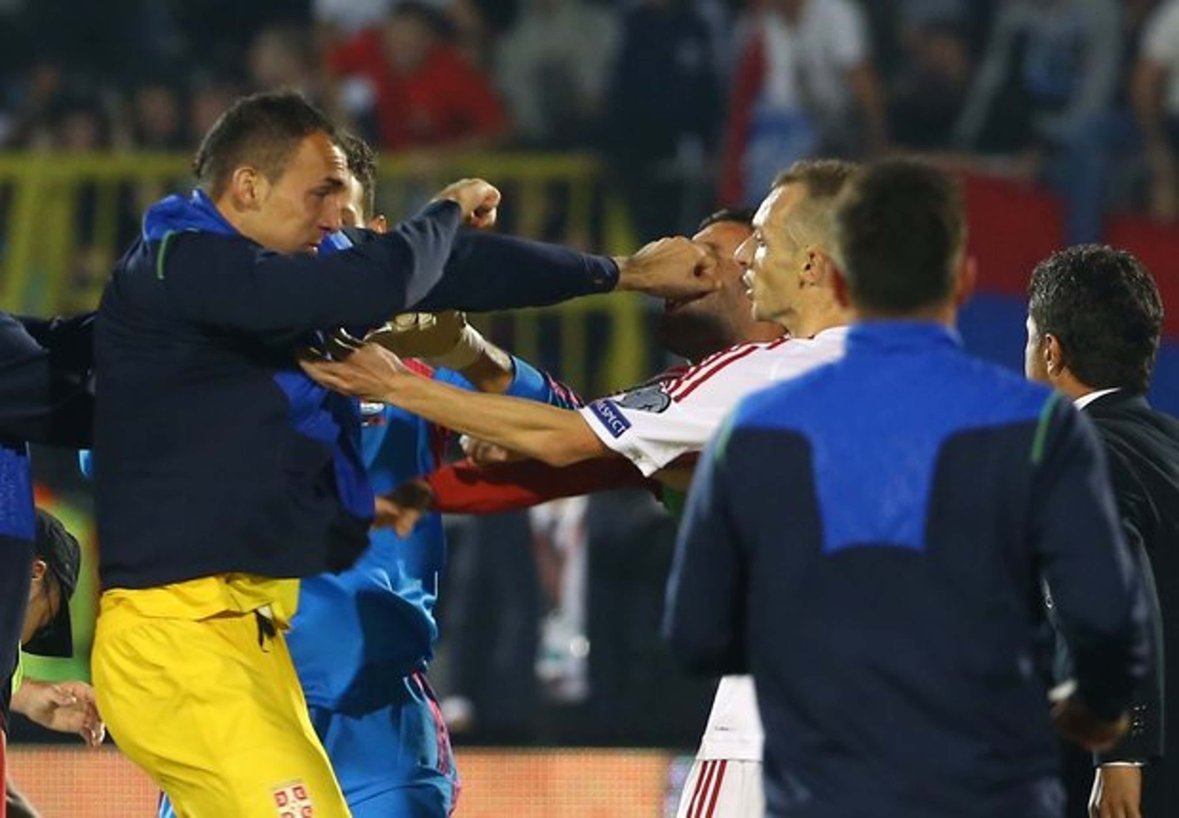 Serbia's Zeljko Brkic punches an Albanian player