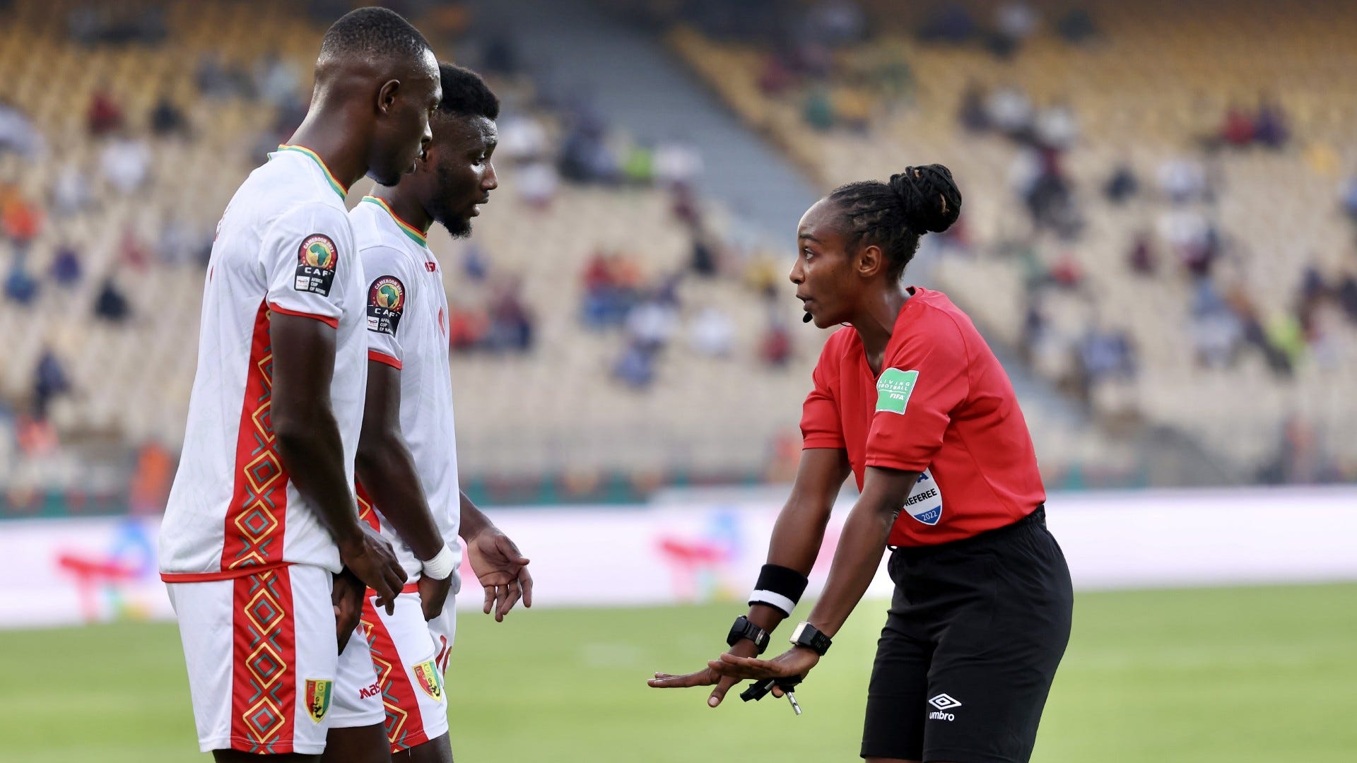 Referee Salima Rhadia Mukansanga of Rwanda talks to players of Guinea.