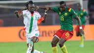Tolo Nouhou of Cameroon (r) challenged by Bertrand Traore of Burkina Faso.