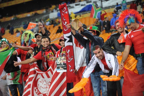 Morocco fans wave their national flag at the start of their match against Angola