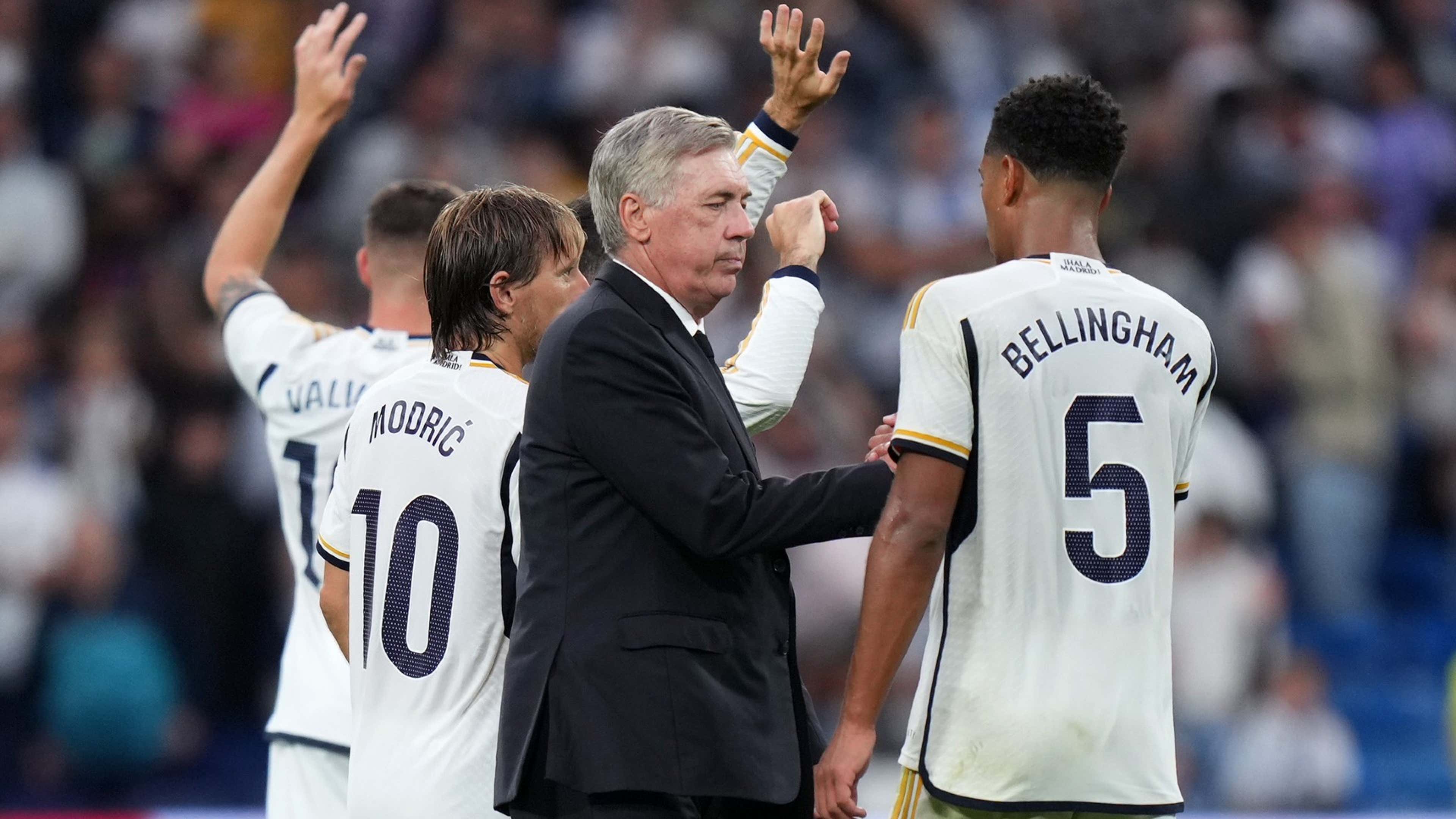 Carlo Ancelotti, Head Coach of Real Madrid, shakes hands with Jude Bellingham